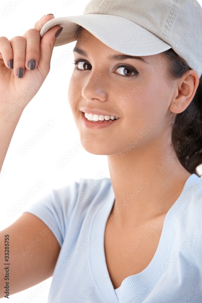 Portrait of young girl in baseball cap smiling Portrait of young girl in baseball cap smiling