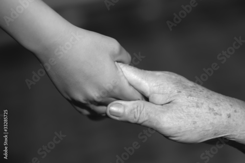 child holding old woman hand
