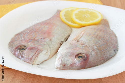 fresh fish with lemon on a plate