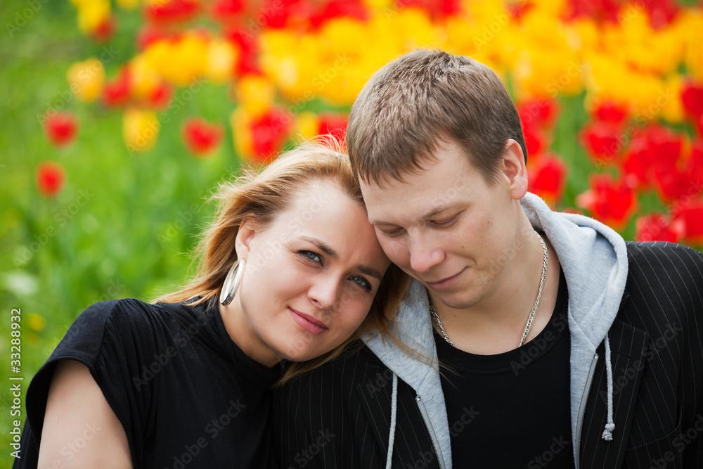 Happy young couple against a nature background Happy young couple against a nature background