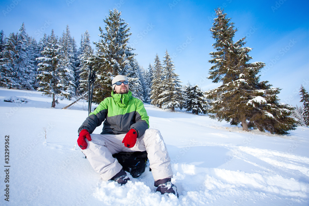 Hiker took a rest in snow forest