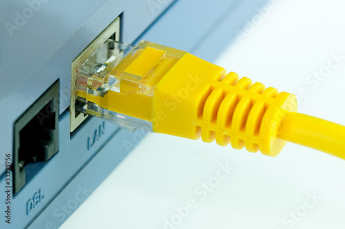 Close up Detail of  RJ45 Yellow Network Cable Connected To Wirel