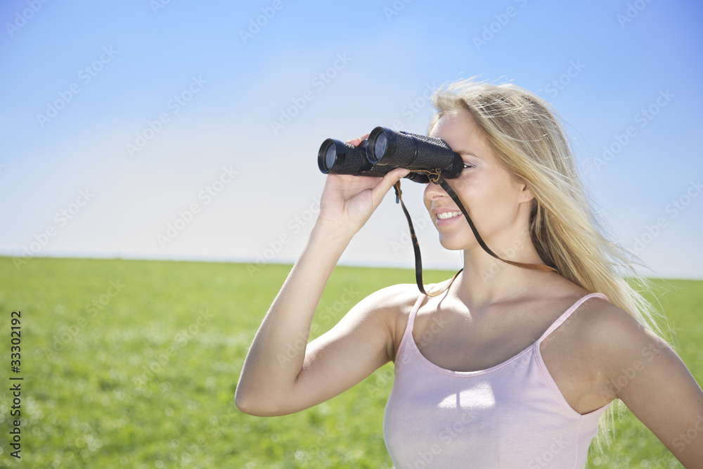 young woman looking through binocular young woman looking through binocular