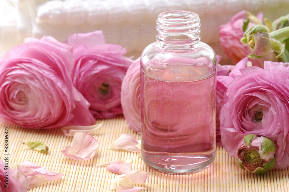 white towel, ranunculus flowers and massage lotion, white towel, ranunculus flowers and massage lotion,