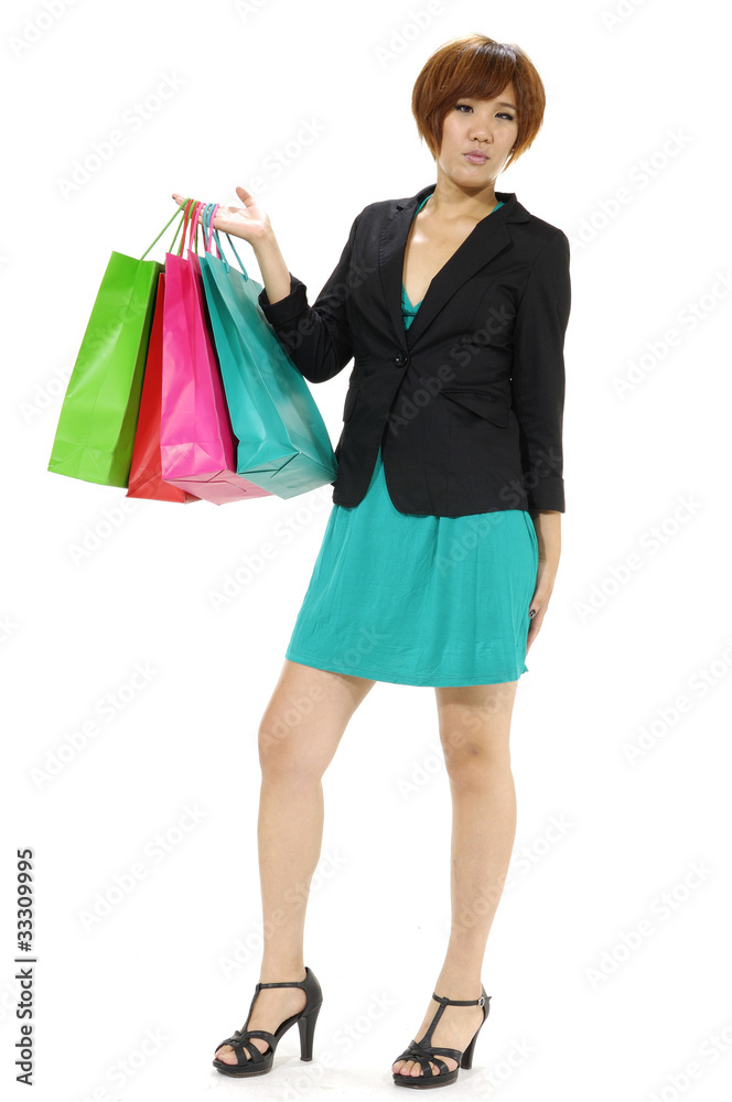 Young casual girl holding shopping colorful bag