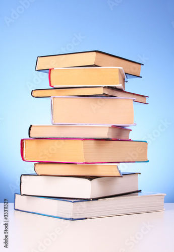 Books pile on the table and yellow background