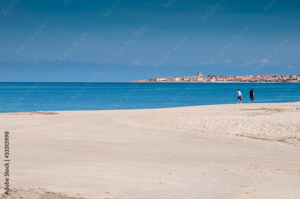 Sardinia, Italy: couple walking on Badesi beach