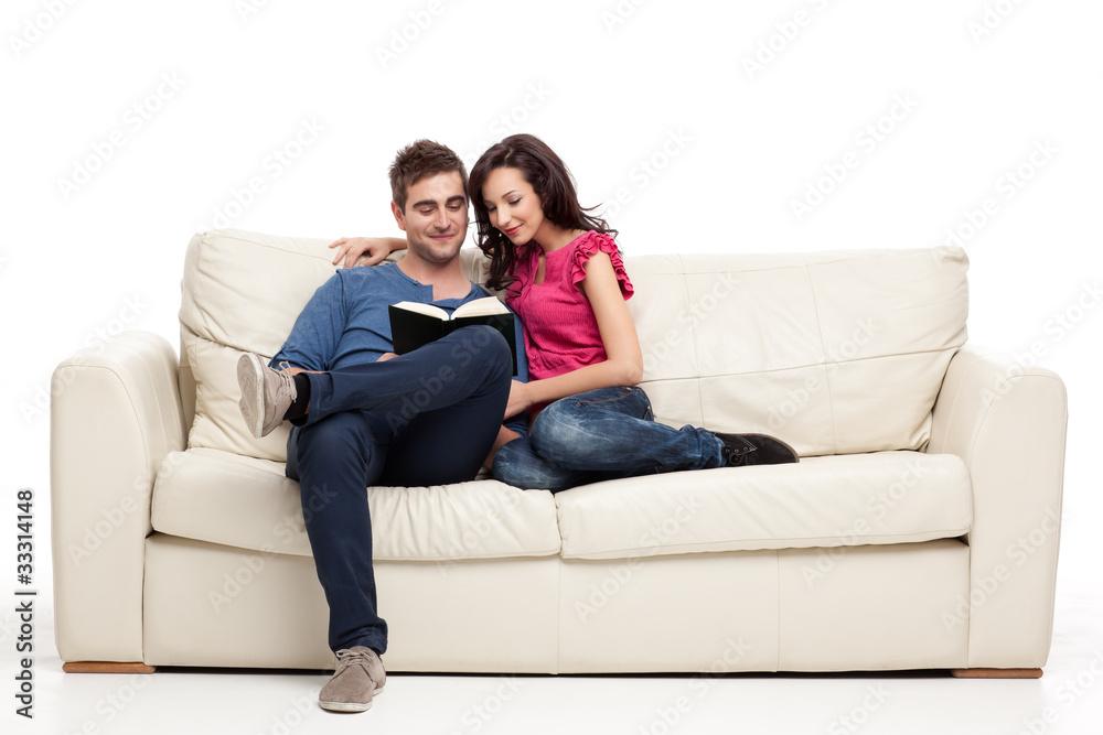 smiling couple reading from book smiling couple reading from book