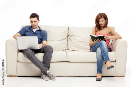 cuple sitting with book and laptop