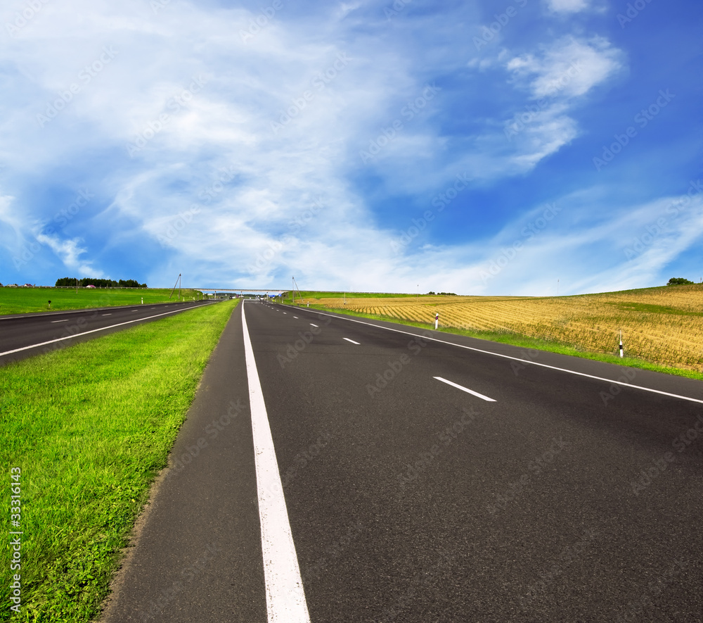 asphalt road over blue sky