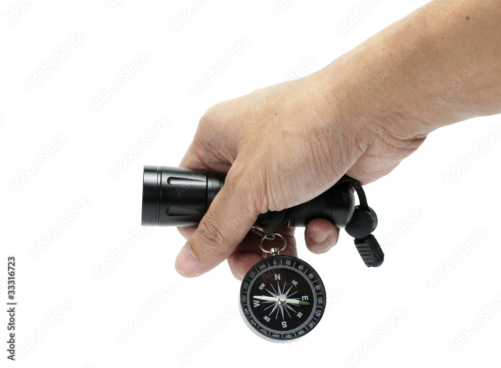 Flashlight and compass in hand Flashlight and compass in hand