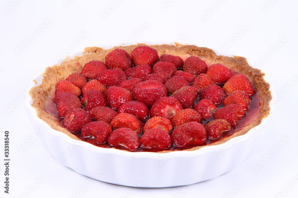 Strawberry Tart in a tart pan on a white background Strawberry Tart in a tart pan on a white background