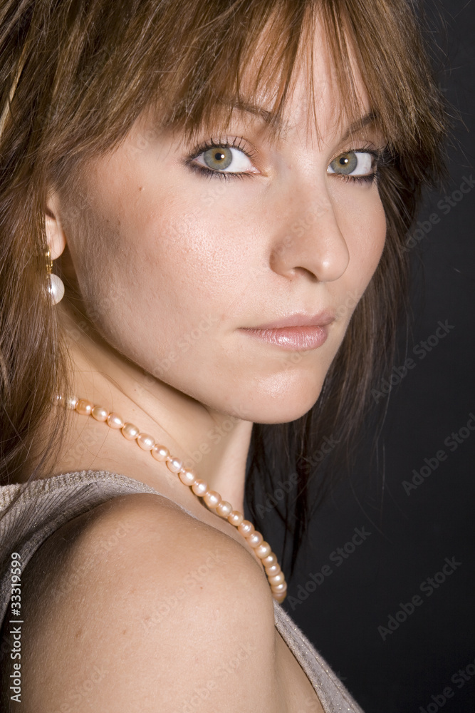 Portrait of a beautiful girl on black background