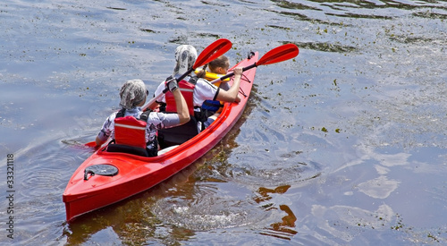 Family of three canoing on a calm river