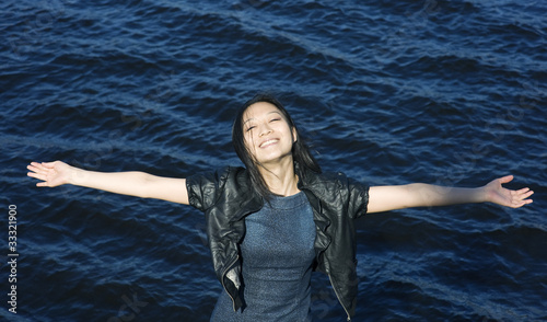 Happy asian woman on the water background © darkbird
