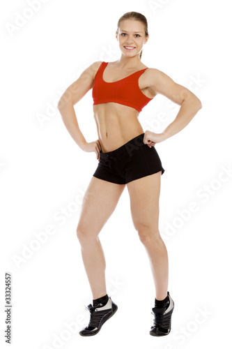 Smiling young sporty woman. Isolated over white background.