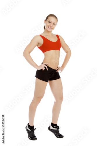 Smiling young sporty muscular woman. Isolated over white backgro