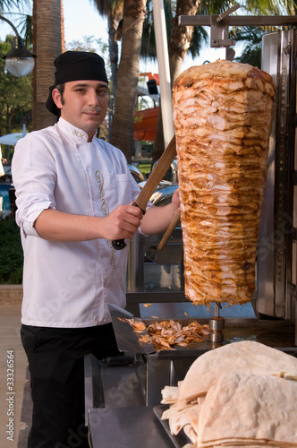 Canvas Print Chef slicing Turkish doner kebab.
