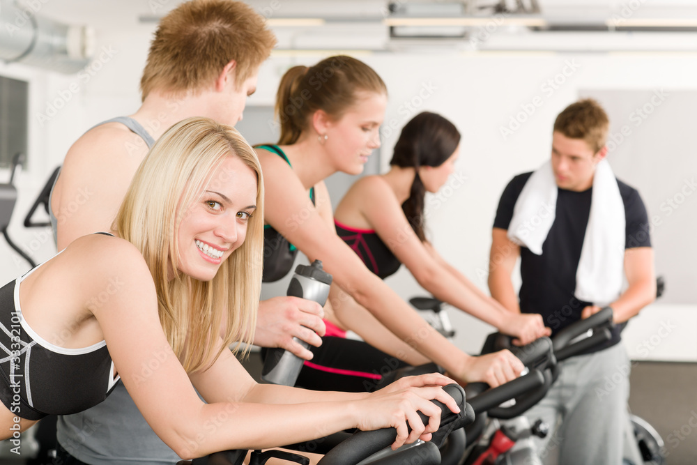 Fitness group of people on gym bike