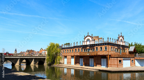 Boat house in the center of Amiens, France. On the shore of the photo