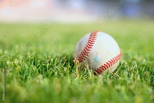 Used baseball on a green grass field