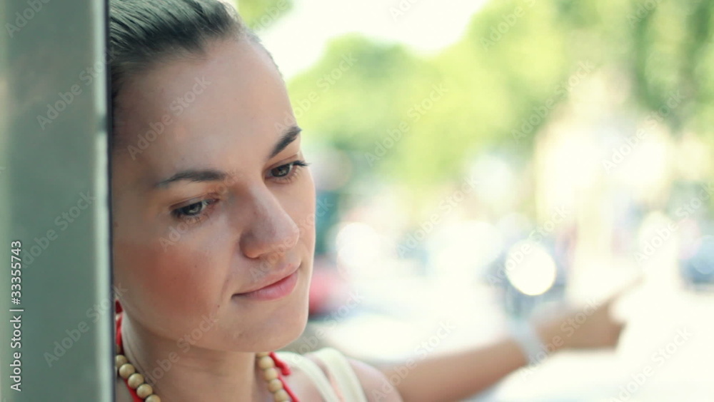 Young sad woman standing by the street, steadycam shot Young sad woman standing by the street, steadycam shot