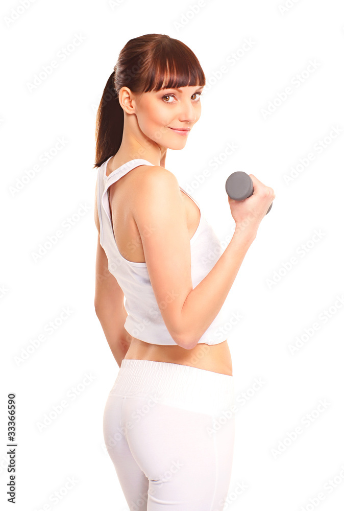 A young and fit brunette woman training with a dumbbell A young and fit brunette woman training with a dumbbell