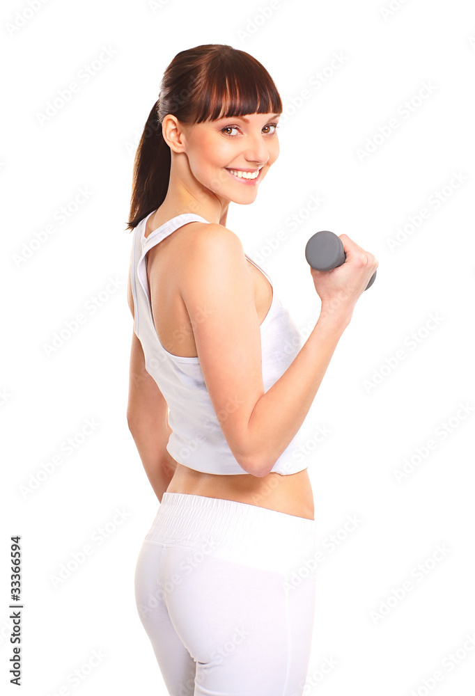 A young and fit brunette woman training with a dumbbell A young and fit brunette woman training with a dumbbell