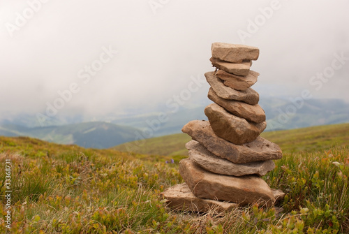 Obraz na płótnie Stack of stones laying in the mountains w salonie