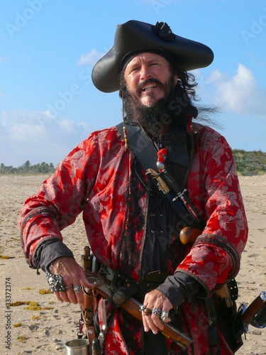 Pirate with weapons on the beach