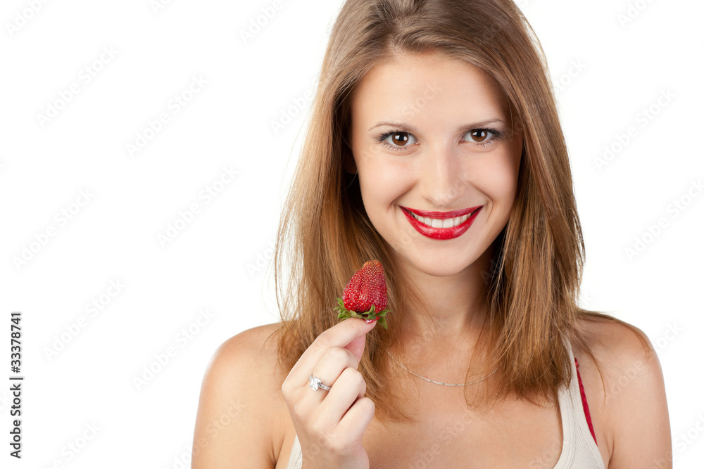 Close-up portrait of young female going to eat strawberry