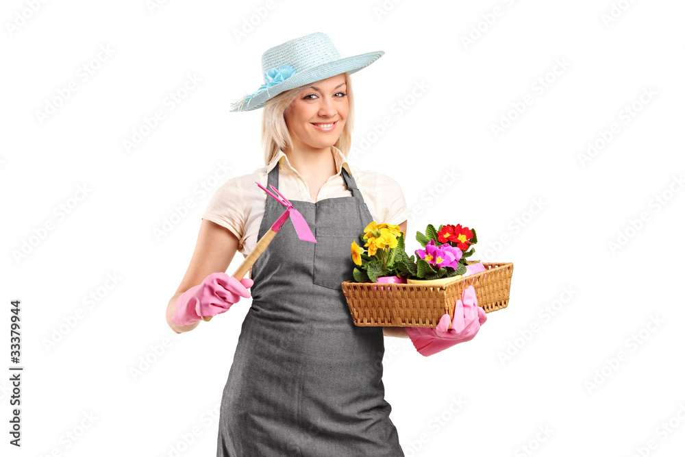 A young florist holding a mattock and flower pots A young florist holding a mattock and flower pots