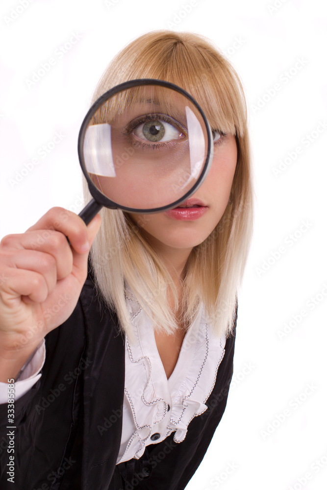 Close-up woman looking through magnifying glass Close-up woman looking through magnifying glass