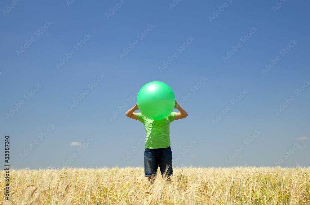 Men with green ball at wheat field. Men with green ball at wheat field.