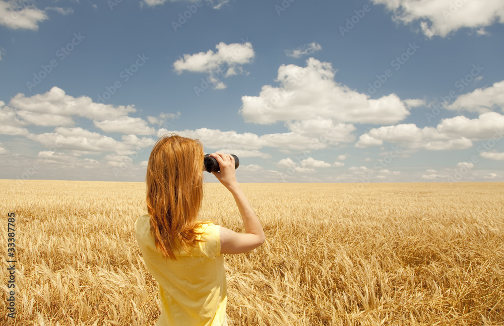 Redhead girl with binocular at wheat field. Redhead girl with binocular at wheat field.