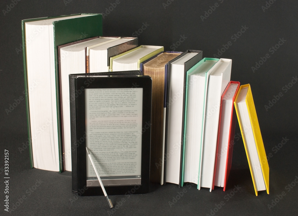 Row of printed books with electronic book reader