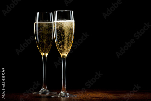 Vászonkép two glass with champagne on a wooden table