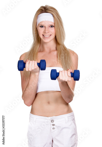Portrait of a smiling sporty woman with a dumbbell on white back