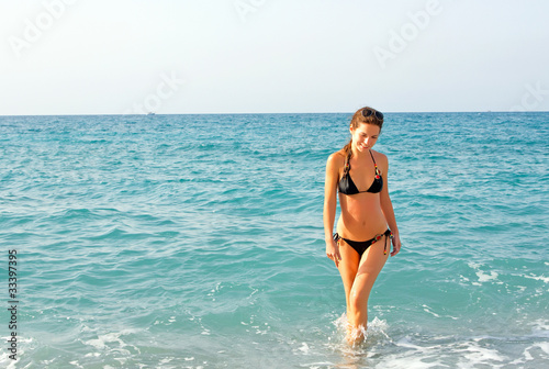 Young woman on the beach © sborisov