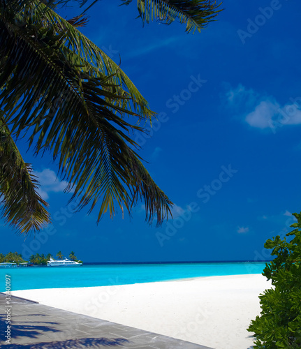 Sand beach and ocean vessels, Ari-Atoll. Maldives