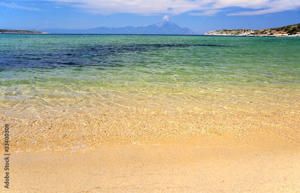 Fototapeta premium Greek beach at Sithonia, Greece, Mount Athos at the background