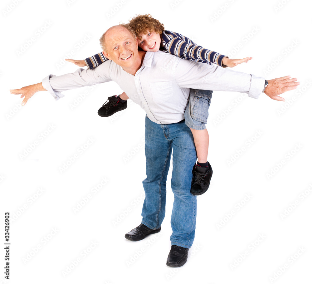 Fototapeta premium Grandfather giving grandson piggy-back