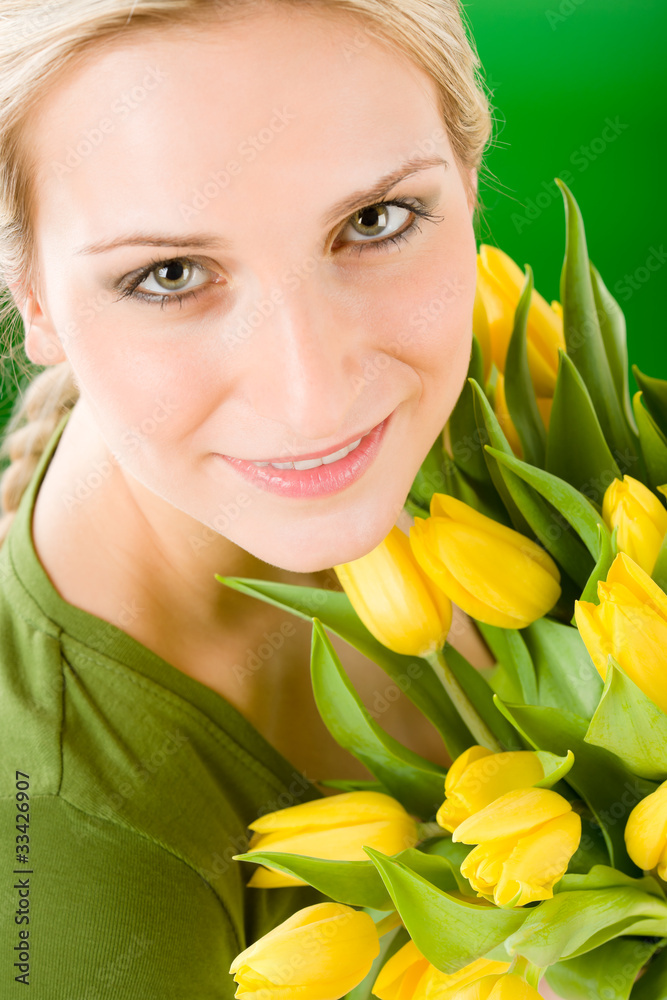 Young happy woman hold yellow tulips flower Young happy woman hold yellow tulips flower