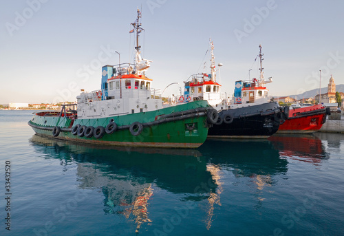 Three tugboats in harbour.