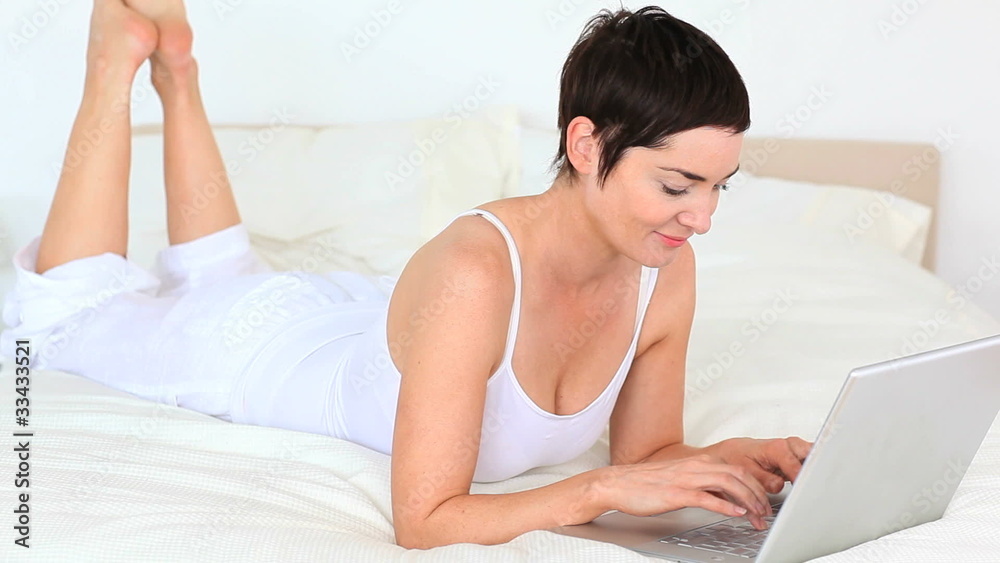 Brunette woman relaxing with a computer Brunette woman relaxing with a computer