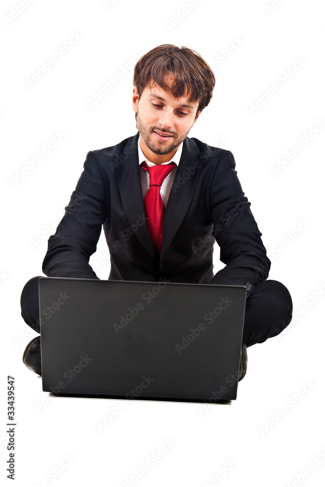 Businessman sitting on the floor while using his laptop Businessman sitting on the floor while using his laptop