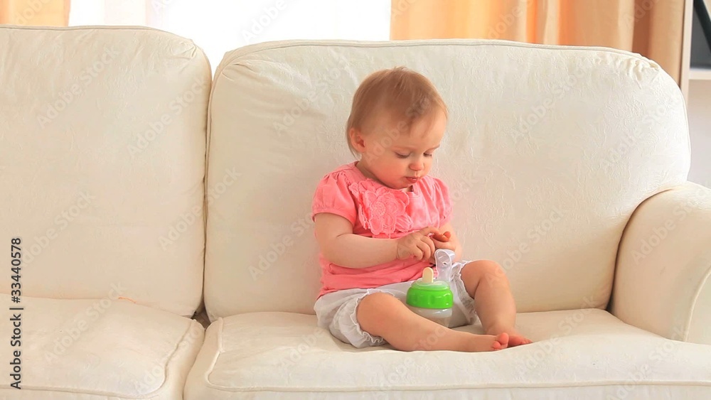 Baby eating on a sofa Baby eating on a sofa