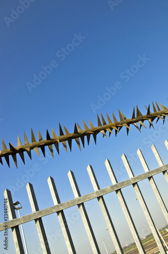 Barbed wire fence at the blue sky. metaphor of freedom