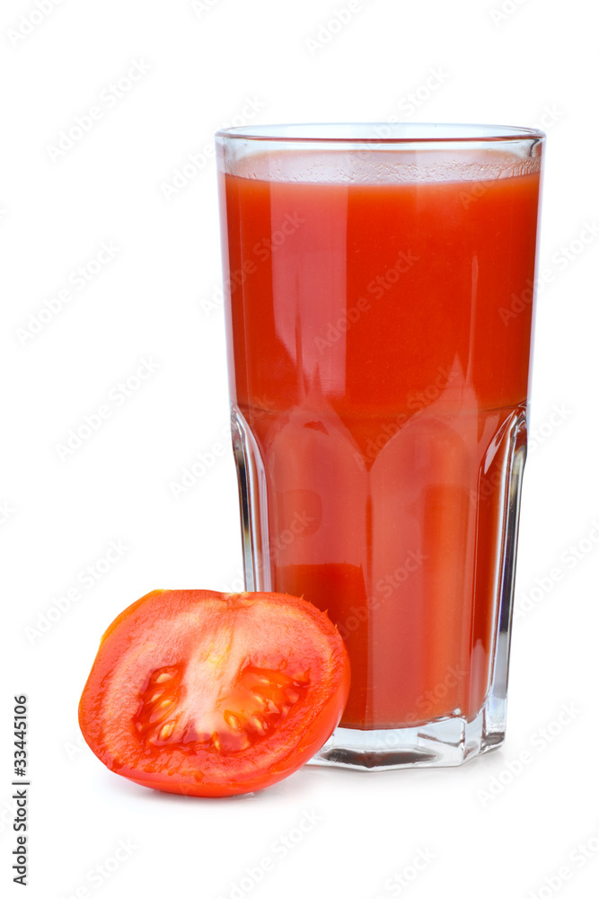 Drinking glass with tomato juice and ripe fresh tomato near Drinking glass with tomato juice and ripe fresh tomato near