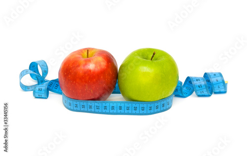 apples and measuring tape on white background
